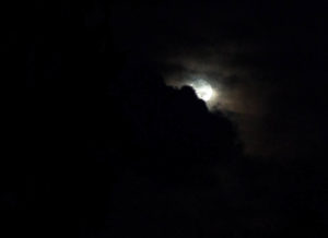 Moon behind faint clouds